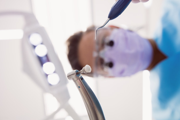 dentist-holding-dental-tools