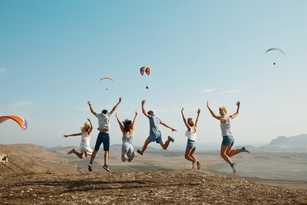 group-friends-jumping-top-hill