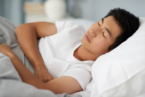 man sleeping on bed