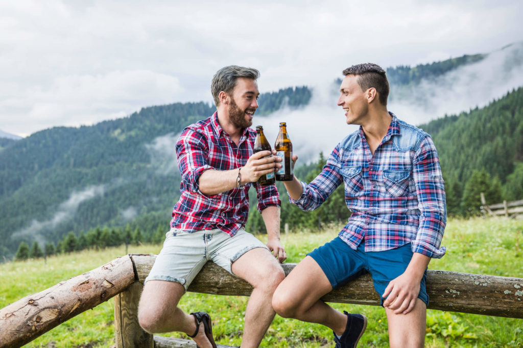 Two men cheering in summer