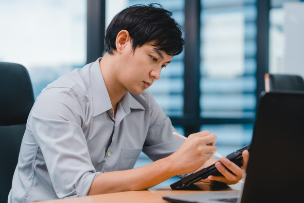 man writing and using pen with digital tablet computer thinking of inspiration search ideas working process in mode