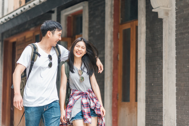 happy couple walking on a street