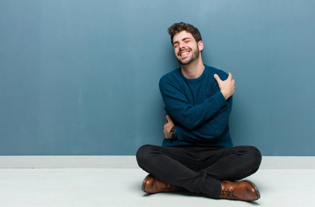 man hugging himself