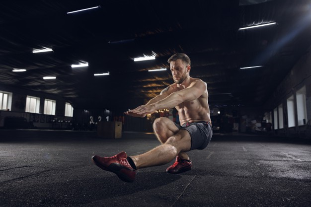young-healthy-man-athlete-doing-balance-exercises-squats-gym-single-model-practicing-hard-training-his-lower-body-concept-healthy-lifestyle-sport-fitness
