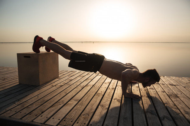 young-healthy-man-doing-push-ups-with-special-equipment