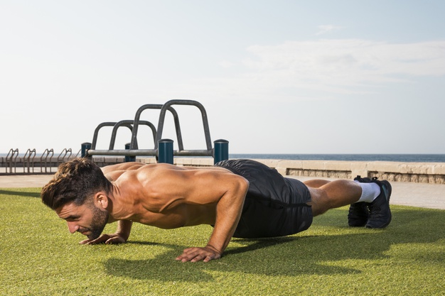 young-man-training-exercise-pushups