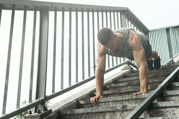 top-view-strong-sportsman-doing-push-ups