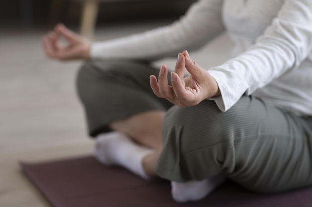 close-up-person-meditating-home
