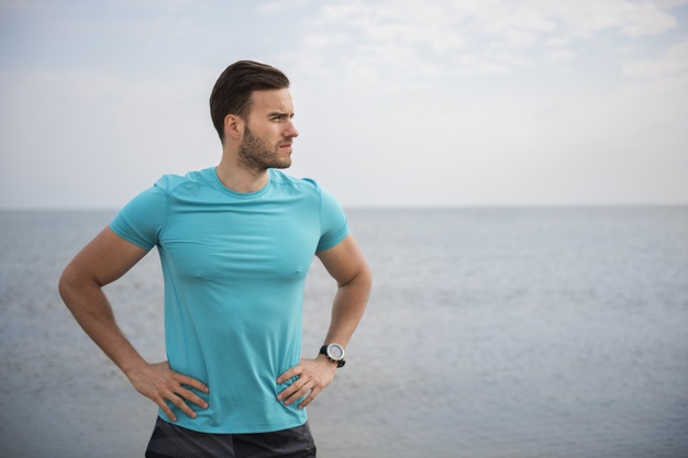 young fit person jogging by the sea
