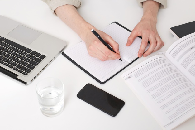 young man hands writing notes