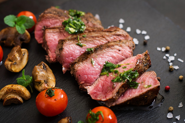 Juicy steak medium rare beef with spices and grilled vegetables