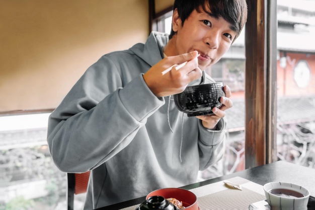 man eating with chopsticks