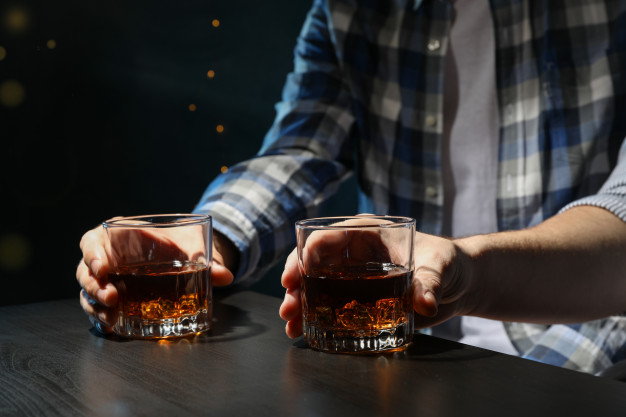 men-drink-whiskey-bar-close-up-blurred-lights-men-drink-whiskey-bar-close-up-blurred-lights