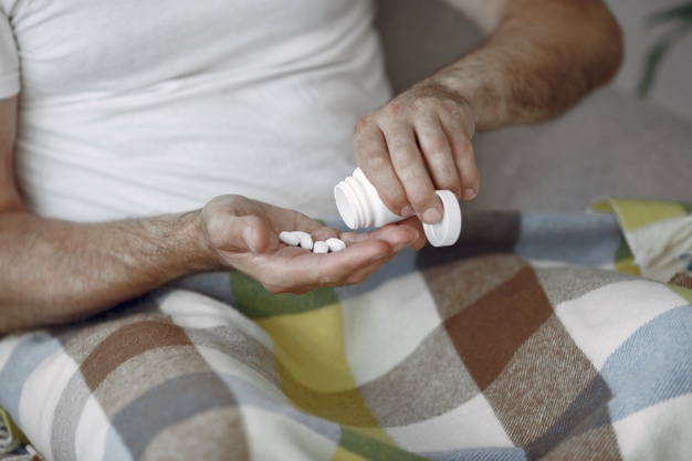 man having pills in hand
