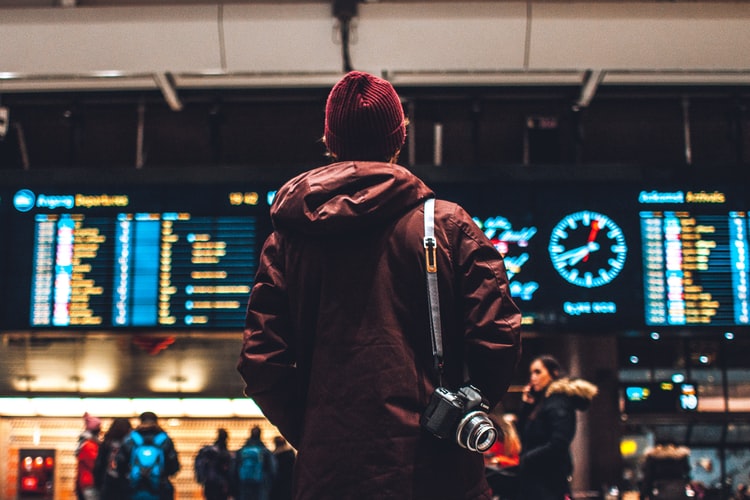 man looking at flight schedule