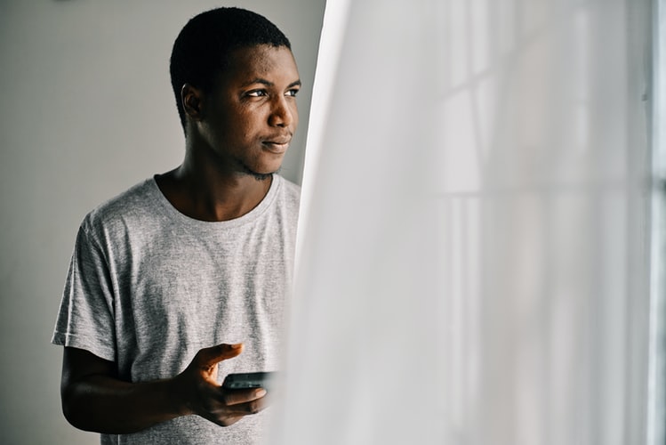 man standing near the window
