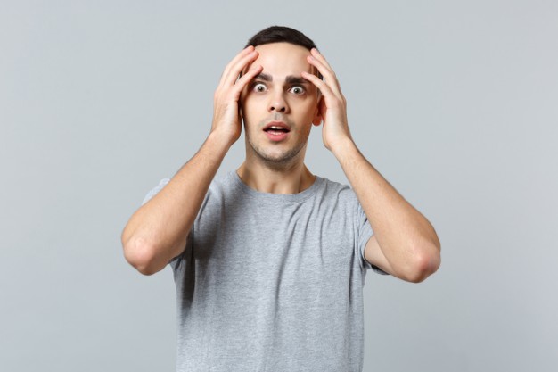 shocked amazed young man in casual clothes,