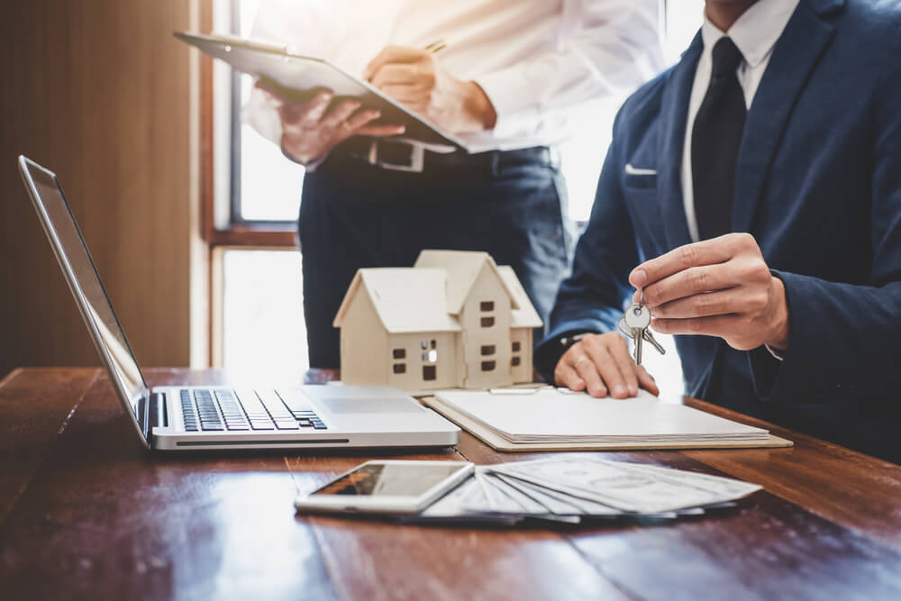 Man Holding House Keys