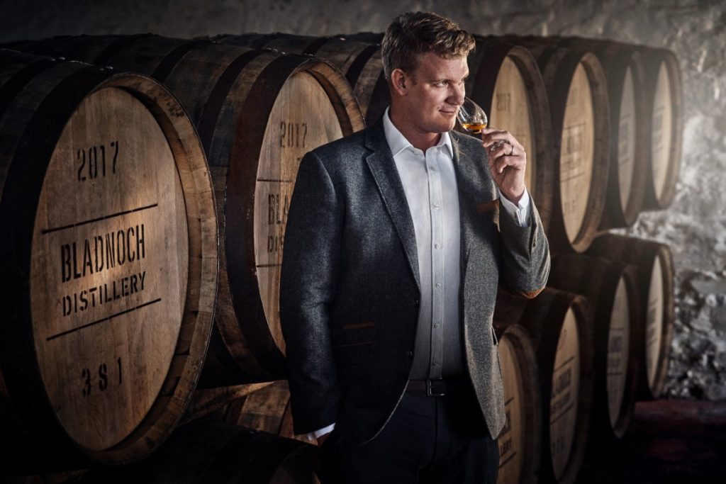Handsome man smelling a whisky