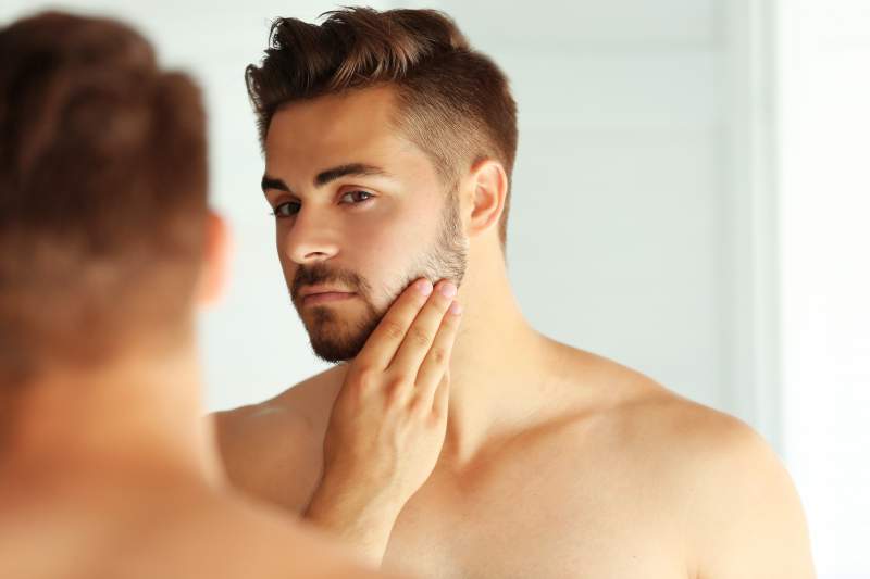 Man touching his face