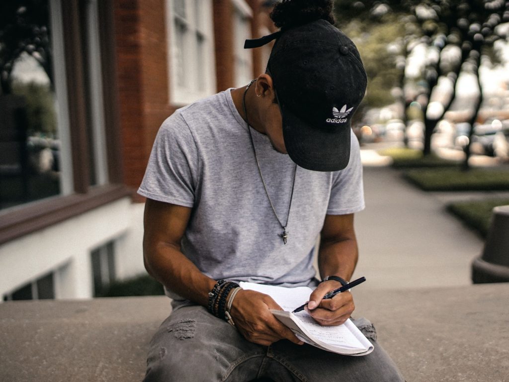 man writing notes