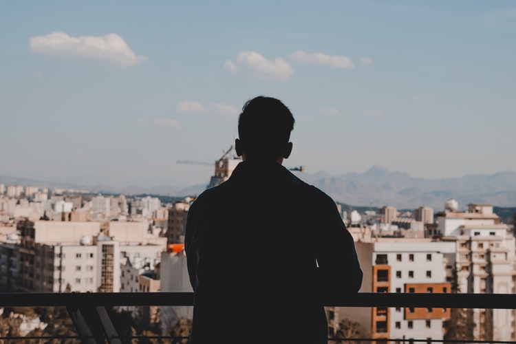man looking at buildings