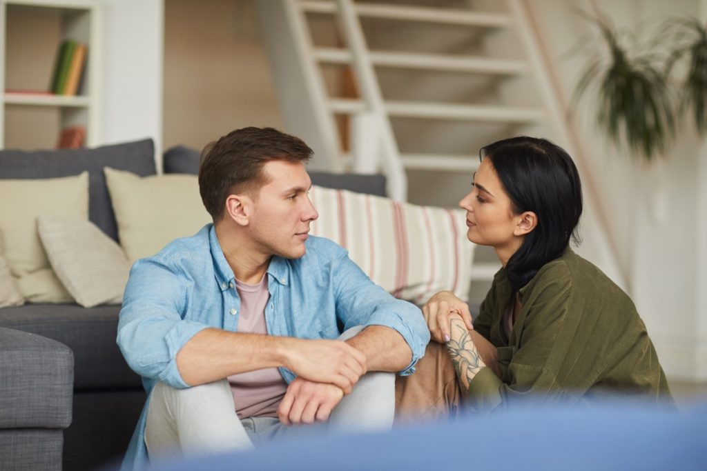  young couple man and woman sit at new home