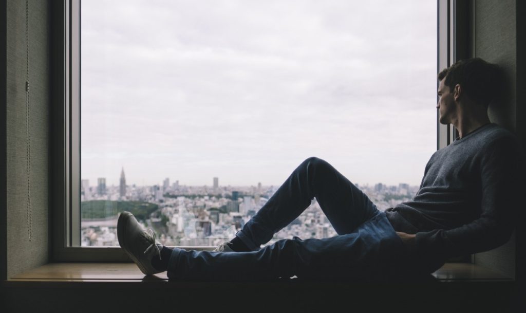 A Lonely Man Sitting at window