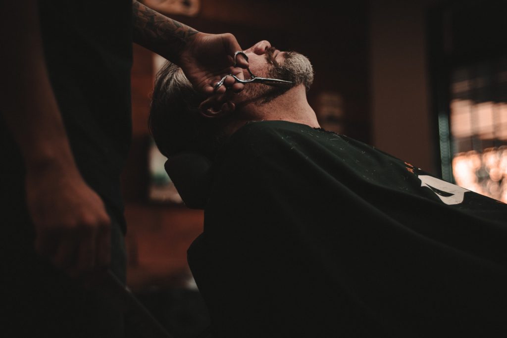 man trimming beard