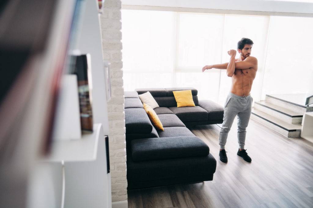 man stretching muscles before starting a workout routine