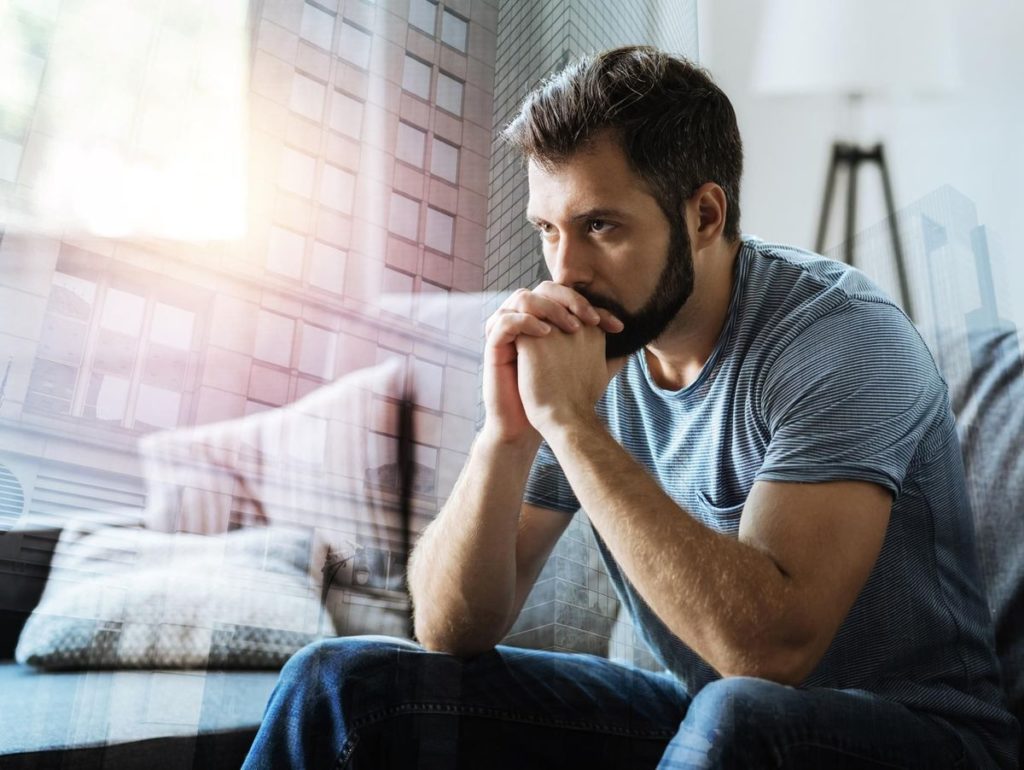 man deep thinking on sofa