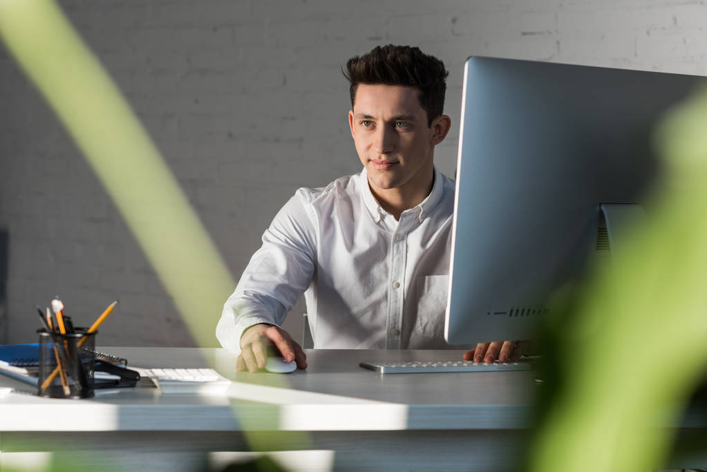 man sitting at workplace in modern office