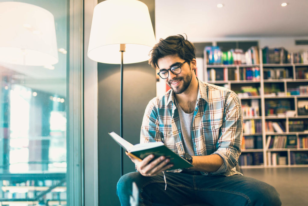 Man reading book at book store
