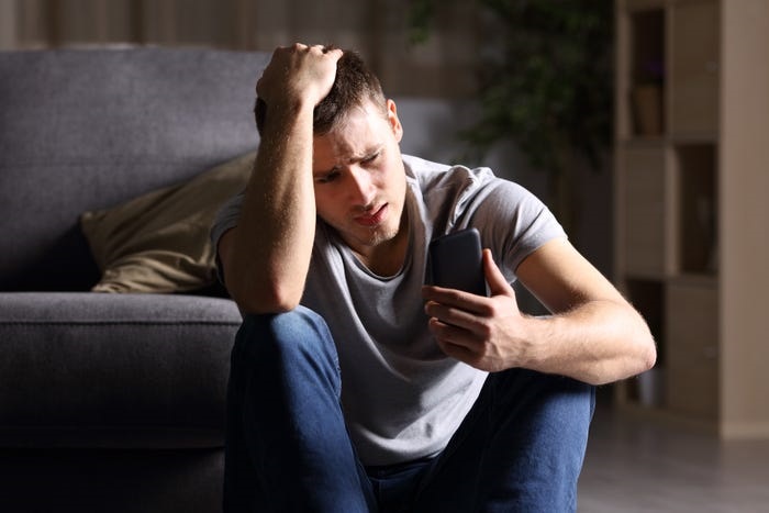 Broken Heart man looking at phone 