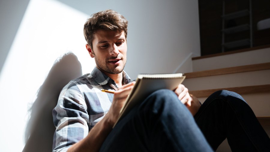  A man writing in a notebook