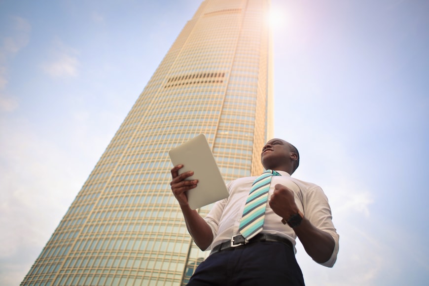 Man cheering in front of building