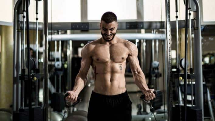 Young fitness man training in gym 