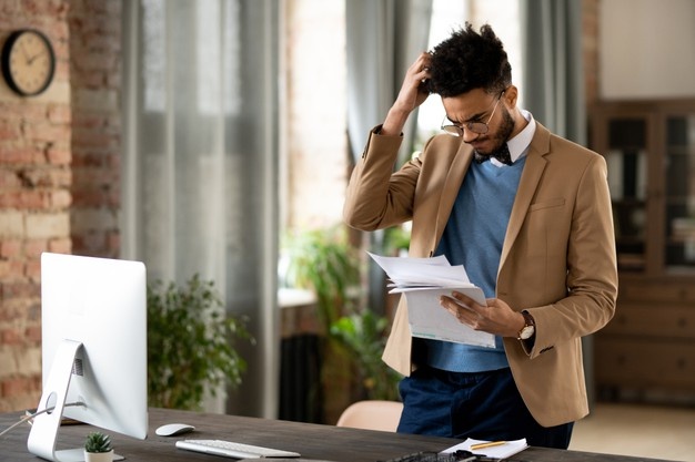 Stressed businessman looking at the papers