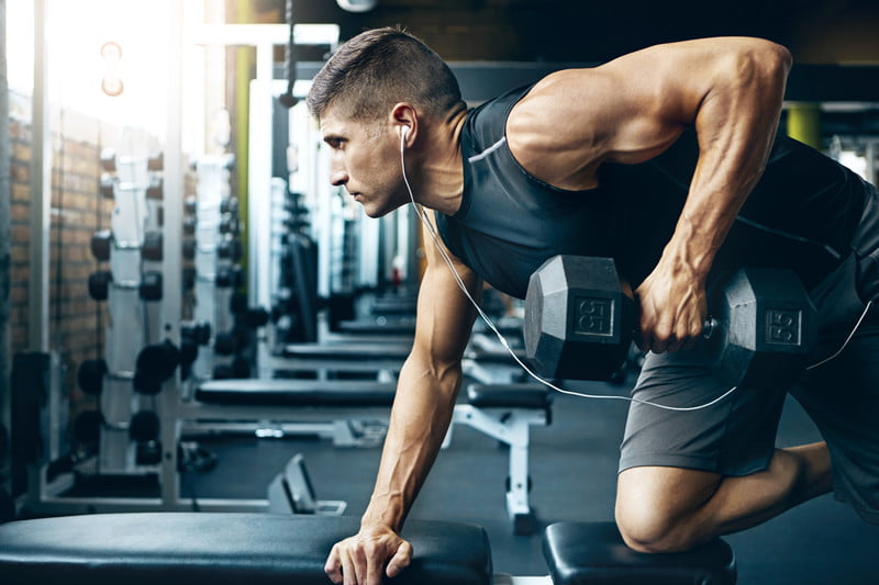 an Workout With Dumbbell In Fitness Gym