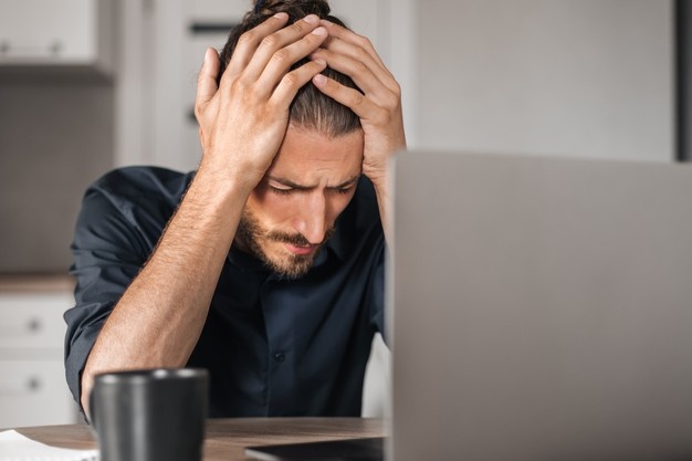 Alone desperate businessman sitting on a desk
