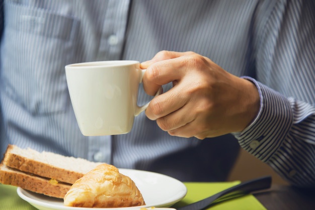  Business man eat the american breakfast set in a hotel