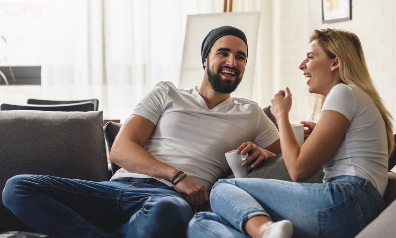 Healthy couple talking on sofa
