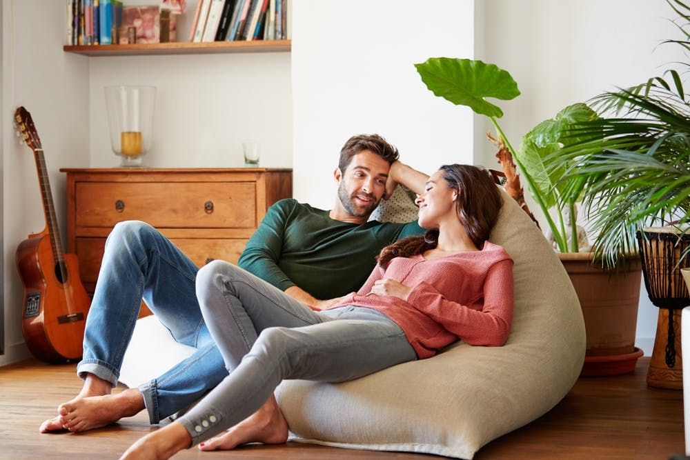 Happy couple talking on bean bag