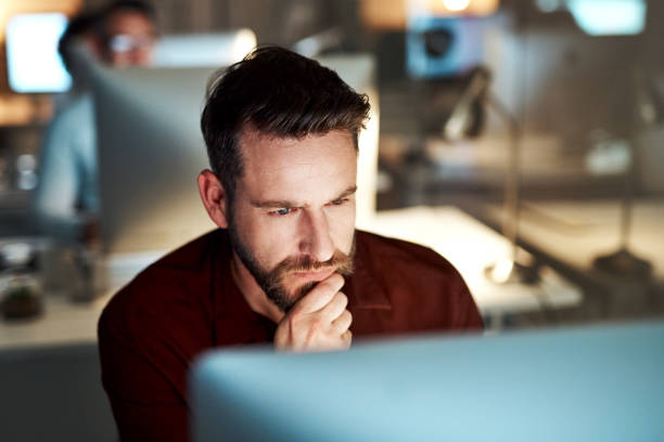 Cropped shot of a handsome young businessman looking thoughtful while working at his desk in the office