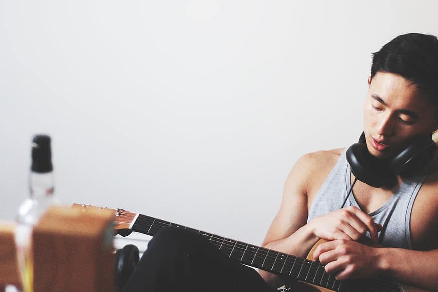 man, playing guitar  