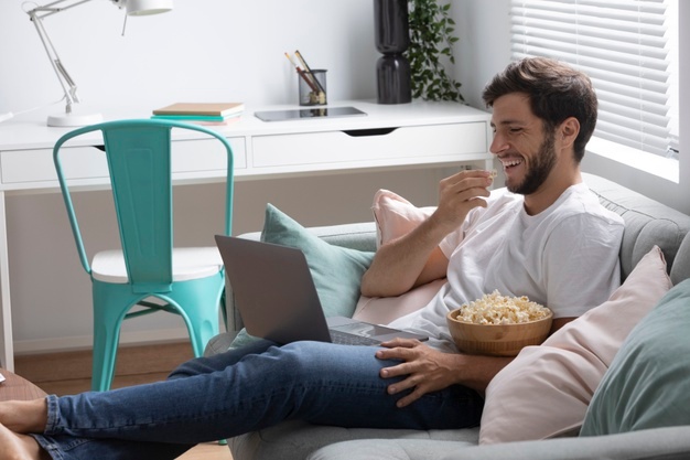 Man watching his favorite movie on a laptop 