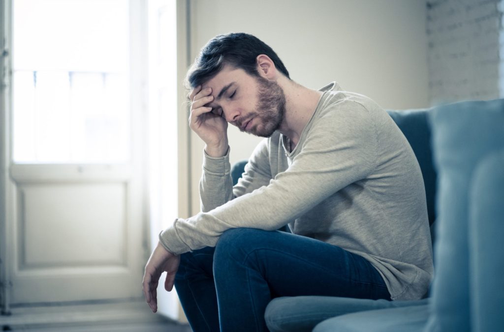 Depressed Man sitting on sofa 