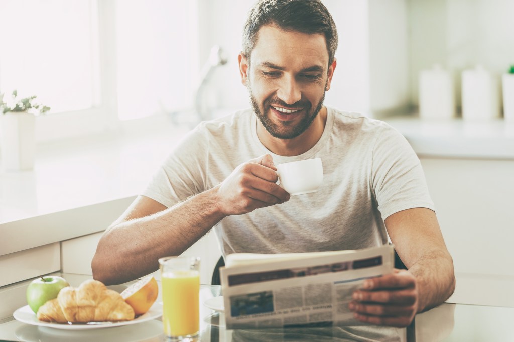 man Reading Newspaper
