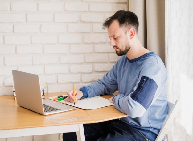 man learning online from laptop