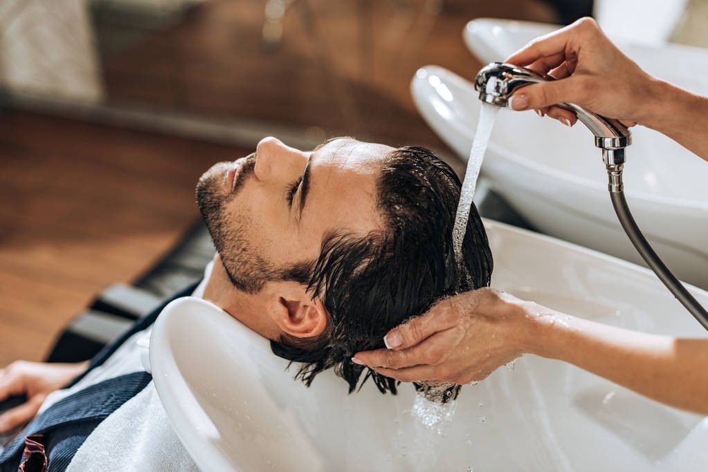Man getting his hair wash at salon